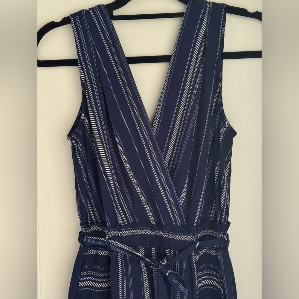 Navy and white wide leg jumpsuit. V front and back. Pockets, tie waist.